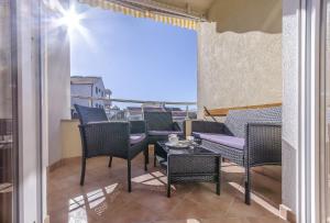 a balcony with chairs and a table with a view at Apartment Zdravko in Srima