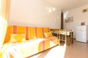 a living room with a couch and a table at Apartment Zdravko in Srima +9 photos