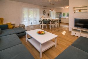 a living room with a couch and a table with a bowl of fruit at Villa Harmony in Risika