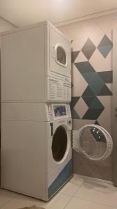 a washing machine and a washer in a room at 68 Brand-new studio next to Paulista Av, fast wifi in Sao Paulo +5 photos