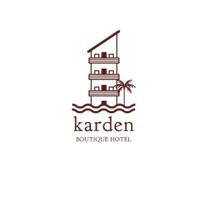 un faro en el océano con una palmera y un edificio en Karden Otel, en Antalya