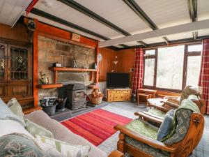 a living room with a couch and a fireplace at Coire-Dhiubh in Glenfinnan