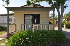 a house with a porch and a fence at Kangerong Holiday Park in Dromana