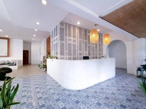 a lobby with a white reception desk in a building at Royal Beach View in Pattaya South