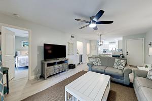 a living room with a couch and a flat screen tv at Fiddlers Cove III in Hilton Head Island