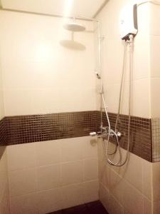 a shower in a bathroom with a glass door at 1bedroom Condo For rent with WiFi pool and gym in Cebu City