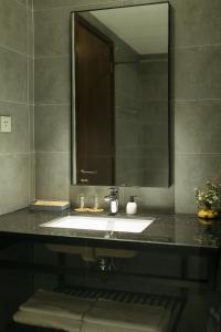 a bathroom with a sink and a mirror at Em Oi Boutique Hotel in Nha Trang