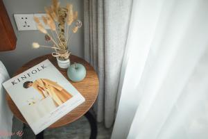 a table with a book and an apple on it at Em Oi Boutique Hotel in Nha Trang
