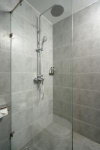 a shower with a glass door in a bathroom at Em Oi Boutique Hotel in Nha Trang