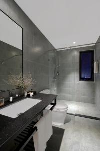 a bathroom with a sink and a toilet at Em Oi Boutique Hotel in Nha Trang
