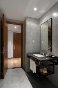a bathroom with a sink and a mirror at Em Oi Boutique Hotel in Nha Trang