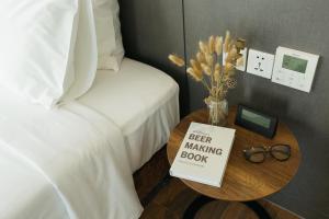 a bed and a table with a bed making book at Em Oi Boutique Hotel in Nha Trang