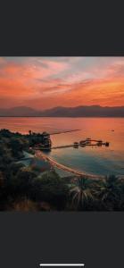 a sunset over a body of water with a beach at Royal Resort in Eilat