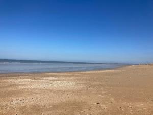a sandy beach with the ocean in the background at Port Homard in Coudeville