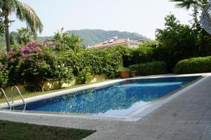 a swimming pool in the yard of a house at Mountain View Villa Marmaris in Marmaris