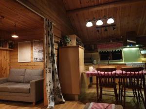 a kitchen with a couch and a table in a room at Nås Camping Dalarna, stuga nr 6 in Nås