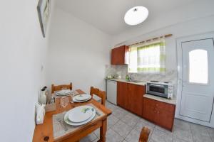 a kitchen with a table and a dining room at Dinos Studios in Paralía Kanalíou