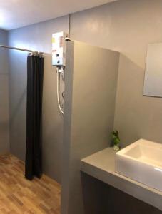 a bathroom with a sink and a shower and a counter at Wooden hostel in Chiang Mai