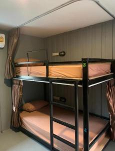 a couple of bunk beds in a room at Wooden hostel in Chiang Mai