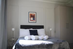 a bedroom with a bed with four towels on it at Crawford House - ScholarLee Living Apartments in Cork