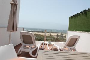 a room with two chairs and a table and a window at Apartamentos Tocororo in Cotillo