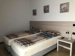 2 Betten nebeneinander in einem Zimmer in der Unterkunft HOME NUOVA OSTIGLIA in Padernello