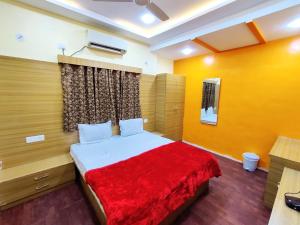 ein Schlafzimmer mit einem Bett mit einer roten Decke in der Unterkunft Hotel Family Inn FOREIGN GUEST ONLY in Aurangabad
