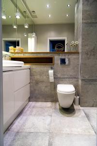 a bathroom with a white toilet and a sink at VIP Apartamenty Białystok in Białystok