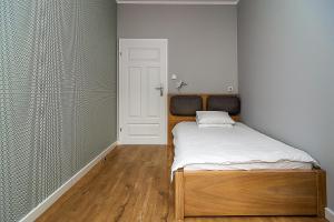 Łóżko lub łóżka w pokoju w obiekcie VIP Apartamenty Białystok
