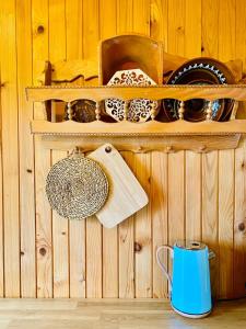 a wooden wall with shelves and a blue coffee mug at Family Peace Chalet Brinovska & Scenic Mt Views in Ortnek