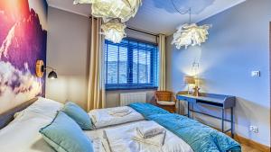 a bedroom with a bed and a desk in it at Apartament Bujać w Obłokach Karpatia - 5D Apartamenty in Karpacz