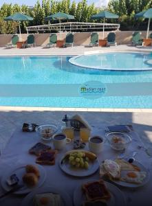 a table topped with plates of food on top of a beach at Mediterranean Hotel Studios Apartments in Kissamos
