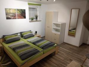 a bedroom with a bed with two pillows at Ferienwohnung Monika Scholtz in Königheim