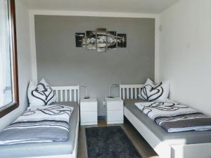 a bedroom with two beds and a rug at Ferienwohnung Monika Scholtz in Königheim