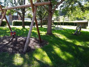 a park with a swing set in the grass at Ferienwohnung Monika Scholtz in Königheim