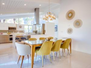 een eetkamer en een keuken met een tafel en stoelen bij La Joya Moderna in Palm Springs