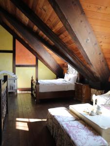 a attic bedroom with two beds and a crib at EOS Resort in Ren'ai