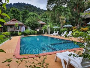 a swimming pool in the middle of a resort at Malulee KhaoSok Resort in Khao Sok
