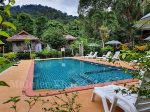 a swimming pool in the middle of a resort at Malulee KhaoSok Resort in Khao Sok National Park