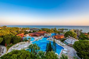 an aerial view of a resort with a swimming pool and the ocean at Cornelia De Luxe Resort in Belek