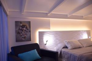 A bed or beds in a room at TRYP by Wyndham Corfu Dassia