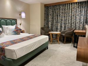 Suvidha Suites客房内的一张或多张床位