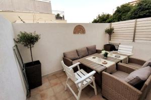 a small patio with a table and chairs at Family & Friends 4-Bedroom beach break! in Athens