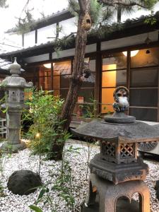 un giardino giapponese con una statua in pietra di fronte a un edificio di 仔鹿 kojika a Nara