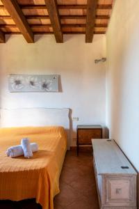 a bedroom with a bed and a bench in a room at Villa Mafaradda a pochi passi dal Mare in Custonaci