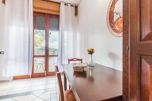 a dining room table with a vase of flowers on it at Terre di mare near the sandy beach with pool, parking & wifi in Fontane Bianche +90 photos