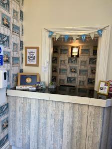 a cashier counter in a store with a computer on it at Cairn House - Bed & Breakfast in Ilfracombe +35 photos