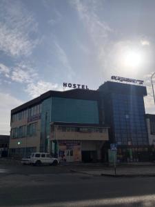 a building with a husetter sign on top of it at Bereke Hostel in Shymkent