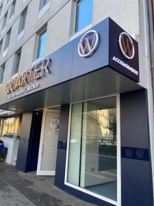 a building with a blue sign on the front of it at Quarter by the Warren Collection in Belfast