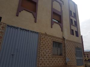 a building with a garage and a window and a door at cap bouya in Aït Farts